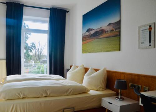 a bedroom with a large bed with a window at Hotel Weinhaus Hoff in Bad Honnef am Rhein