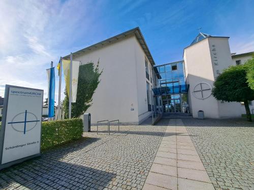 a building with a sign in front of it at Spectrum Kirche Exerzitien-und Bildungshaus auf Mariahilf in Passau