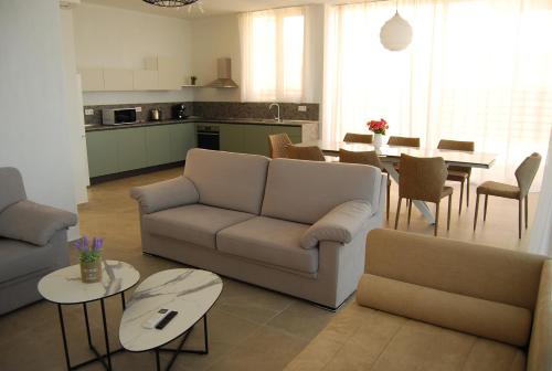 a living room with a couch and a table at Coral Luxury Villas in Lozenets