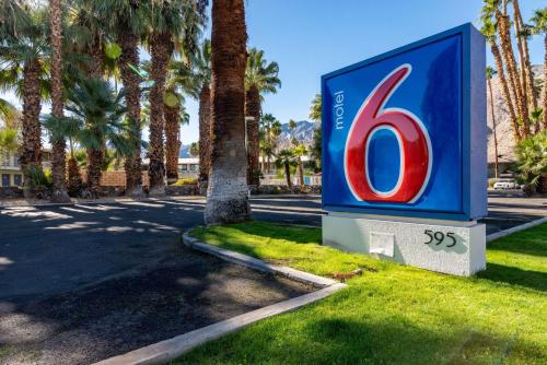 a sign for a gas station with palm trees at Motel 6-Palm Springs, CA - East - Palm Canyon in Palm Springs