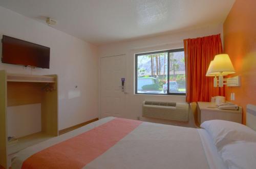 a hotel room with a bed and a window at Motel 6-Palm Springs, CA - East - Palm Canyon in Palm Springs