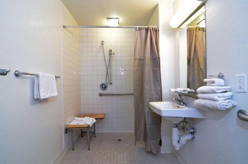 a bathroom with a shower and a sink at Motel 6-Palm Springs, CA - East - Palm Canyon in Palm Springs