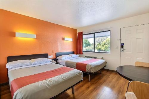 Habitación de hotel con 2 camas y mesa en Motel 6-Sunnyvale, CA - South, en Sunnyvale