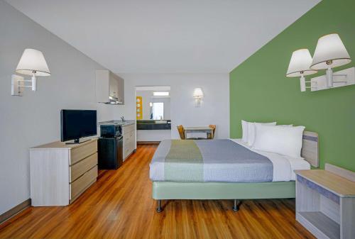 a hotel room with a bed and a television at Motel 6-Tallahassee, FL - Downtown in Tallahassee