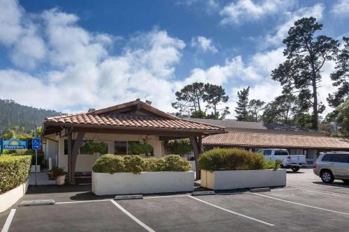 a parking lot with a building with a gazebo at Days Inn by Wyndham Monterey-Fisherman's Wharf Aquarium in Monterey