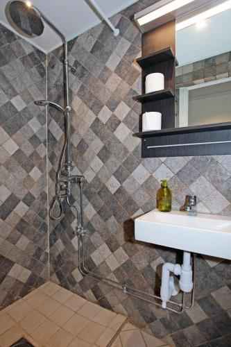 a bathroom with a sink and a shower at Eight Rooms in Stockholm