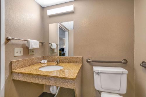 a bathroom with a sink and a toilet and a mirror at Motel 6-Elk Grove Village, IL - O'Hare in Elk Grove Village