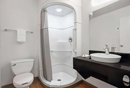 a bathroom with a shower and a toilet and a sink at Motel 6-Troutdale, OR - Portland East in Troutdale