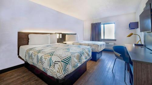 una camera d'albergo con letto e scrivania di Motel 6-Milwaukee, WI - Glendale a Glendale