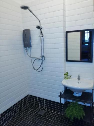 a bathroom with a shower and a sink at Great Shanghai Guesthouse in George Town