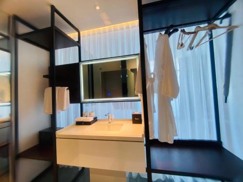 a bathroom with a sink and a mirror at NEWCC HOTEL AND SERVICED APARTMENT in Quang Ngai