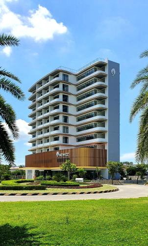 a large white building with a sign on it at NEWCC HOTEL AND SERVICED APARTMENT in Quang Ngai