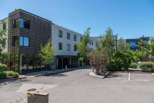 an empty street in front of a building at Ibis Budget Archamps Porte de Genève in Archamps