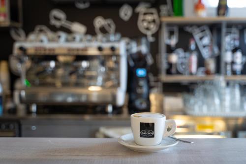 a cup of coffee sitting on a table at Camping Il Capannino Glamping Village in Marina di Bibbona