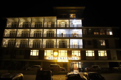 a hotel with a lit up building at night at Hotel Maenamla Namchi - yagi group in Namchi
