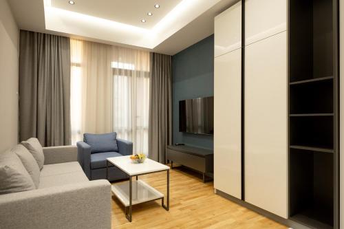 a living room with a couch and a table at Hilltop North Avenue by Stellar Hotels, Yerevan in Yerevan