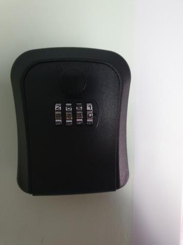 a black electrical outlet with four buttons on a wall at Apartman Franko - SELF CHECK IN in Osijek