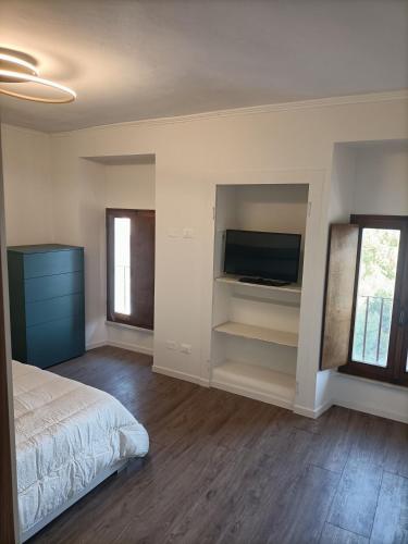 a bedroom with a bed and a flat screen tv at Vistalago in Gargnano