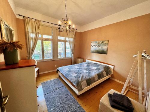 a bedroom with a bed and a ladder in it at Saunaga korter Pärnu ranna vahetus läheduses in Pärnu