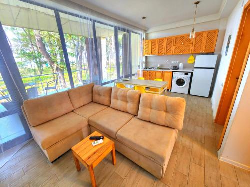 ein Wohnzimmer mit einem Sofa und einem Tisch in der Unterkunft beachfront apartments ,,kapro-one,, in Ureki