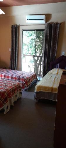 a hotel room with two beds and a window at Hospedaje San Miguel in Luque