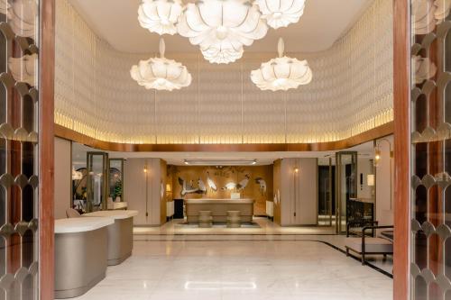 a lobby with two chandeliers and a salon at Hanoi Le Jardin Hotel & Spa in Hanoi