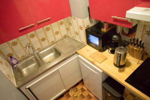 a small kitchen with a sink and a microwave at L'or dans la mer 2 in Nice