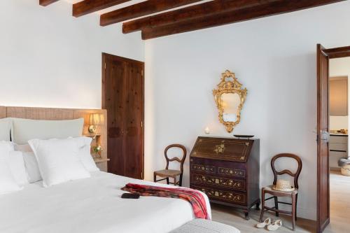 a bedroom with a white bed and a dresser at Ca'n Puig de Sòller in Sóller