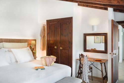 a bedroom with two beds and a table and a mirror at Ca'n Puig de Sòller in Sóller