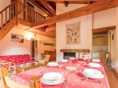 une salle à manger avec une table avec des assiettes et des verres à vin dans l'établissement Chalet spacieux 8 pers. avec cheminée et TV à Serre-Chevalier, Chantemerle - FR-1-330E-19, à Saint-Chaffrey