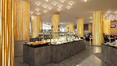 a restaurant with a buffet of food on display at Terme Olimia - Hotel Sotelia in Podčetrtek