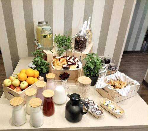 a table topped with boxes of food and snacks at Citi Hotel's Wrocław in Wrocław