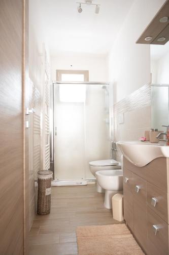 a bathroom with a shower and a toilet and a sink at Dimora Rose in Nardò