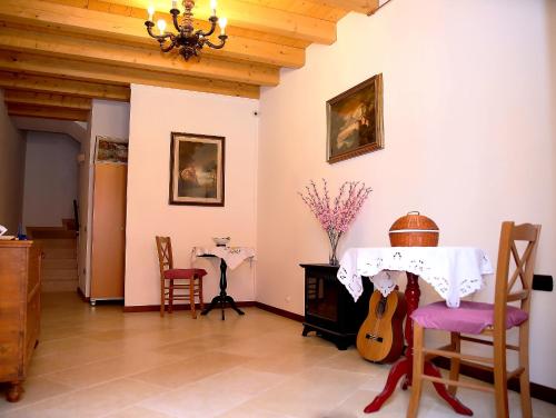 a dining room with a table and a guitar at B&B San Marco in Lonigo