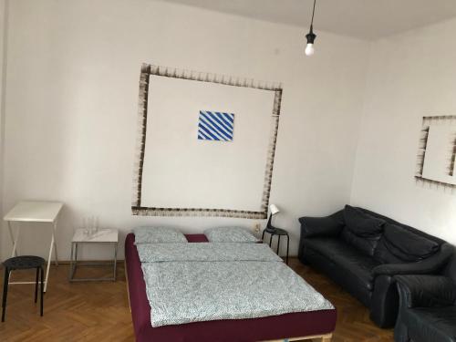 a living room with a bed and a couch at Pokój 11A in Krakow