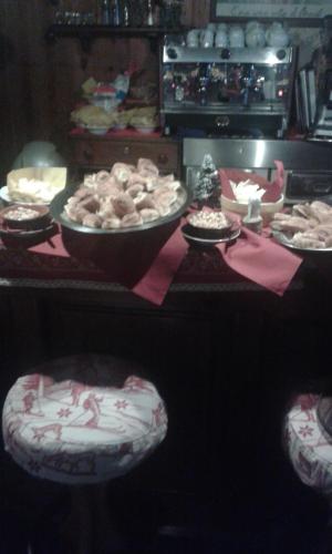 a table with plates of food and bowls of food at Hotel Etoile De Neige in Valtournenche