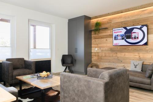 a living room with a couch and a table at AvenidA Style Appartements by Alpin Rentals - incl Summercard in Kaprun