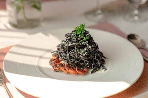 a white plate of food on a table at Hanoi Le Jardin Hotel & Spa in Hanoi