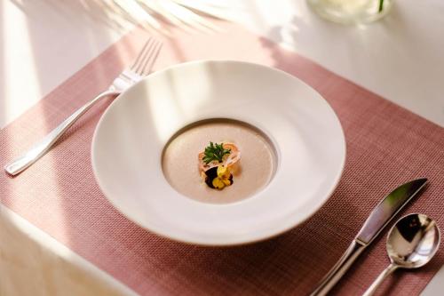 a white plate with food on a table at Hanoi Le Jardin Hotel & Spa in Hanoi