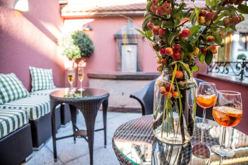 a table with a vase of flowers and wine glasses at Landhotel Restaurant zur Krone in Gottenheim