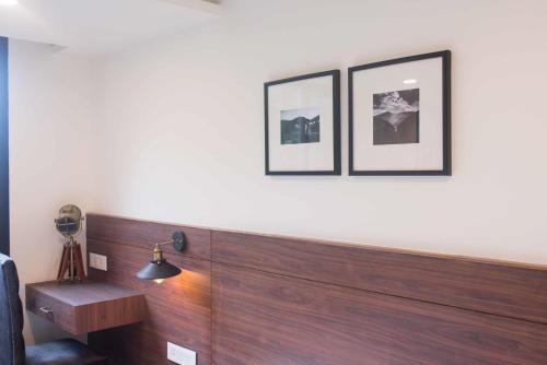 a room with two pictures on the wall and a lamp at Tree of Life Indra Mandala Hotel, Gangtok in Gangtok