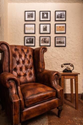 a brown leather chair sitting in a room with a table at Tree of Life Indra Mandala Hotel, Gangtok in Gangtok
