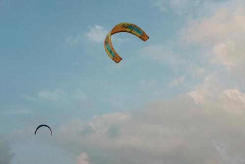two kites are flying in the sky at Luna Laguna in Kalpitiya