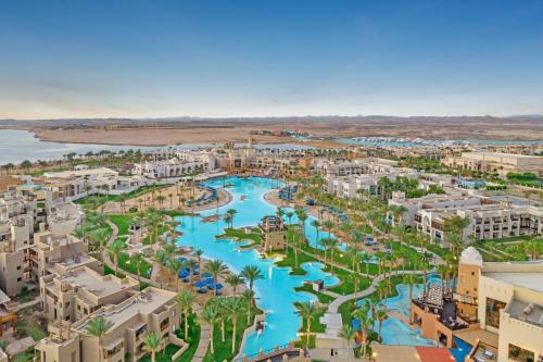 an aerial view of a resort with a river at Pickalbatros Oasis Port Ghalib in Port Ghalib