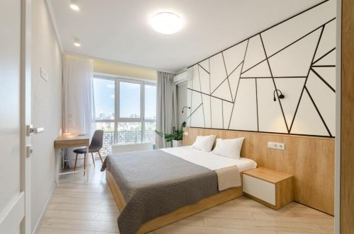 a hotel room with a bed and a desk at Petrovdom 41b-59b-90b-77b stunning City View apartments at RC Kvartet, Central Railway Station in Kyiv
