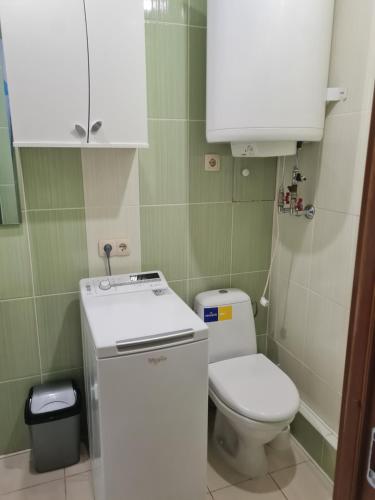 a small bathroom with a toilet and a sink at Ziemielu mols apartaments/pirmā līnija pie jūras in Liepāja