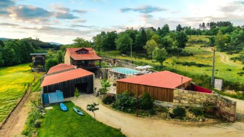 an overhead view of a building with a pool and a house at Casa da Várzea - Serra da Estrela in Fornos de Algodres