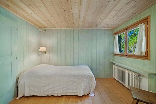 a bedroom with a bed and a wooden ceiling at Chesa Alvan - Surlej in Surlej