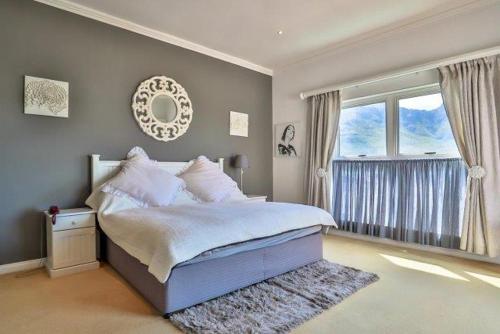 a bedroom with a large bed and a window at Apartments Hout Bay in Cape Town