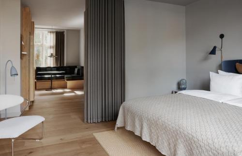 a bedroom with a bed and a living room at Apartments by Brøchner Hotels in Copenhagen